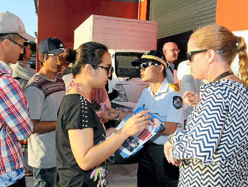INVESTIGATION: Fair Work inspectors talk with strawberry workers. INVESTIGATION: Fair Work inspectors talk with strawberry workers.